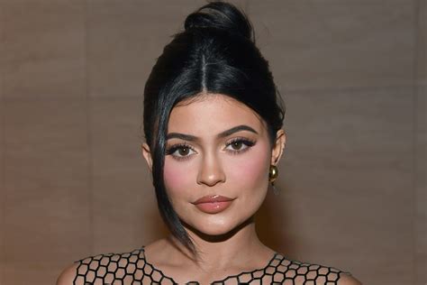 Kylie Jenner shows off thong in sheer dress .